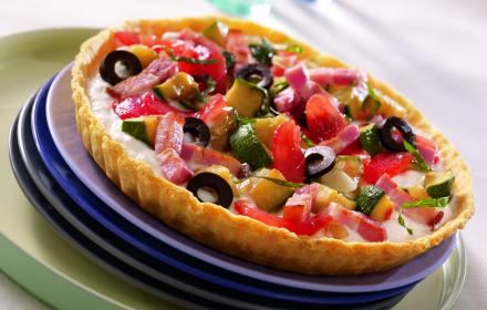 Tarte aux tomates, courgettes, olives et petits lardons grillés